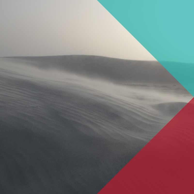 An image of a mountainous landscape with mist streaming along the hills